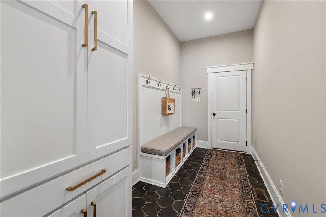 7237 Bonallack Bend, Carlton Ridge, Moseley, VA 23120 Built-in storage cabinetry with gold-finish hardware, built-in bench with integrated storage, wall-mounted coat hooks, recessed lighting, and hexagon tile flooring