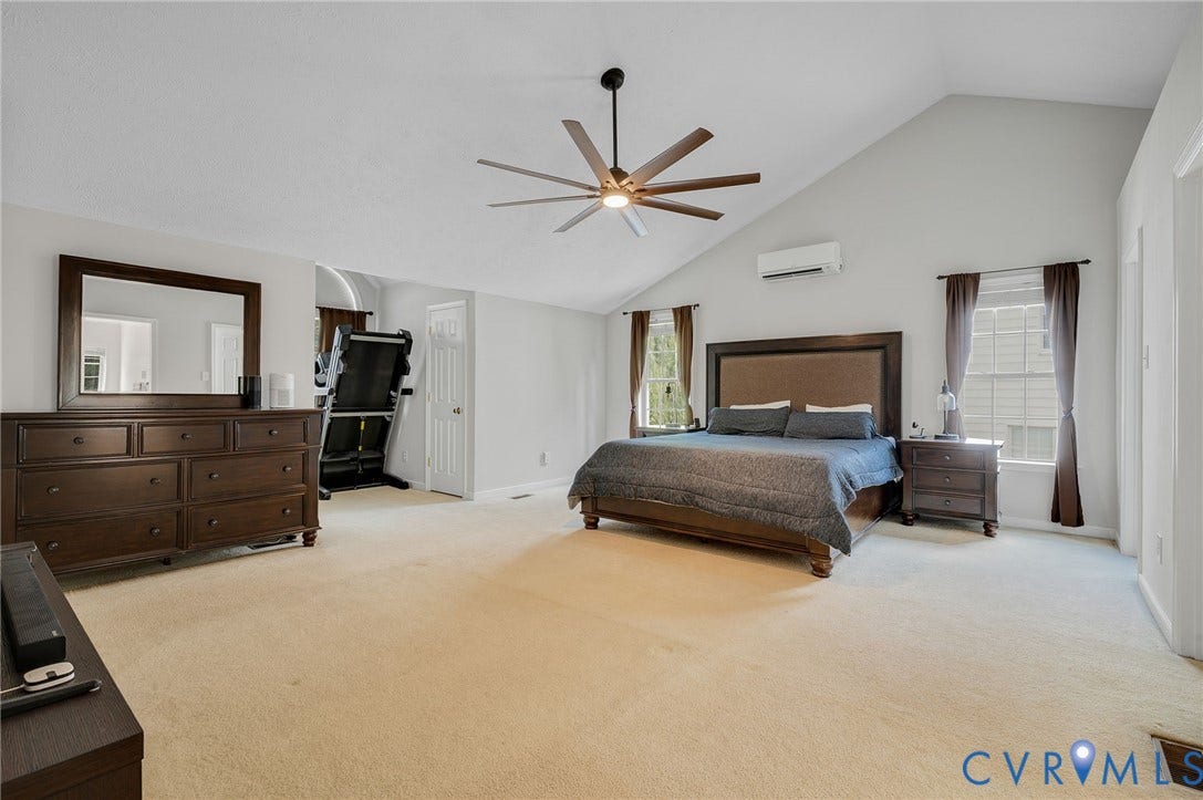 10620 Correnty Drive, Henrico, VA 23059 Spacious carpeted Primary bedroom featuring a vaulted ceiling with a contemporary ceiling fan, dual windows and 2 walk in closets
