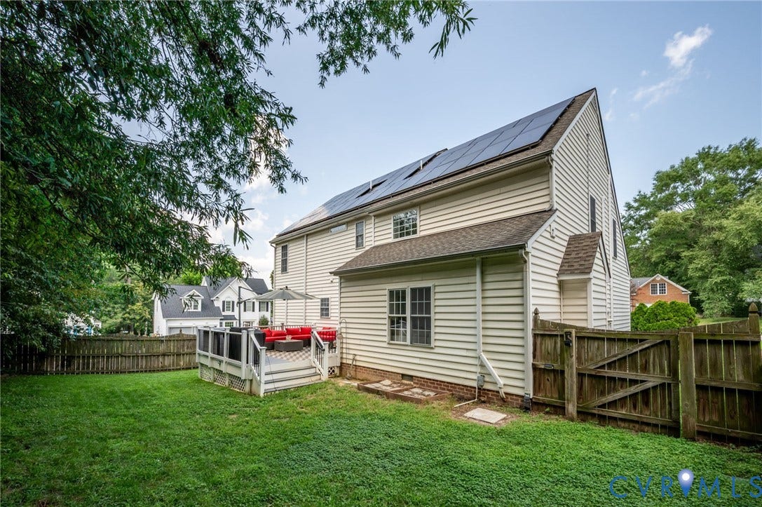 10620 Correnty Drive, Henrico, VA 23059 Rear exterior featuring an elevated deck, solar panels, horizontal siding, and a wood privacy fence