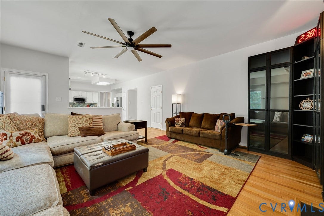 10620 Correnty Drive, Henrico, VA 23059 Spacious living area featuring light-toned walls, wood-finish flooring, and a contemporary ceiling fan