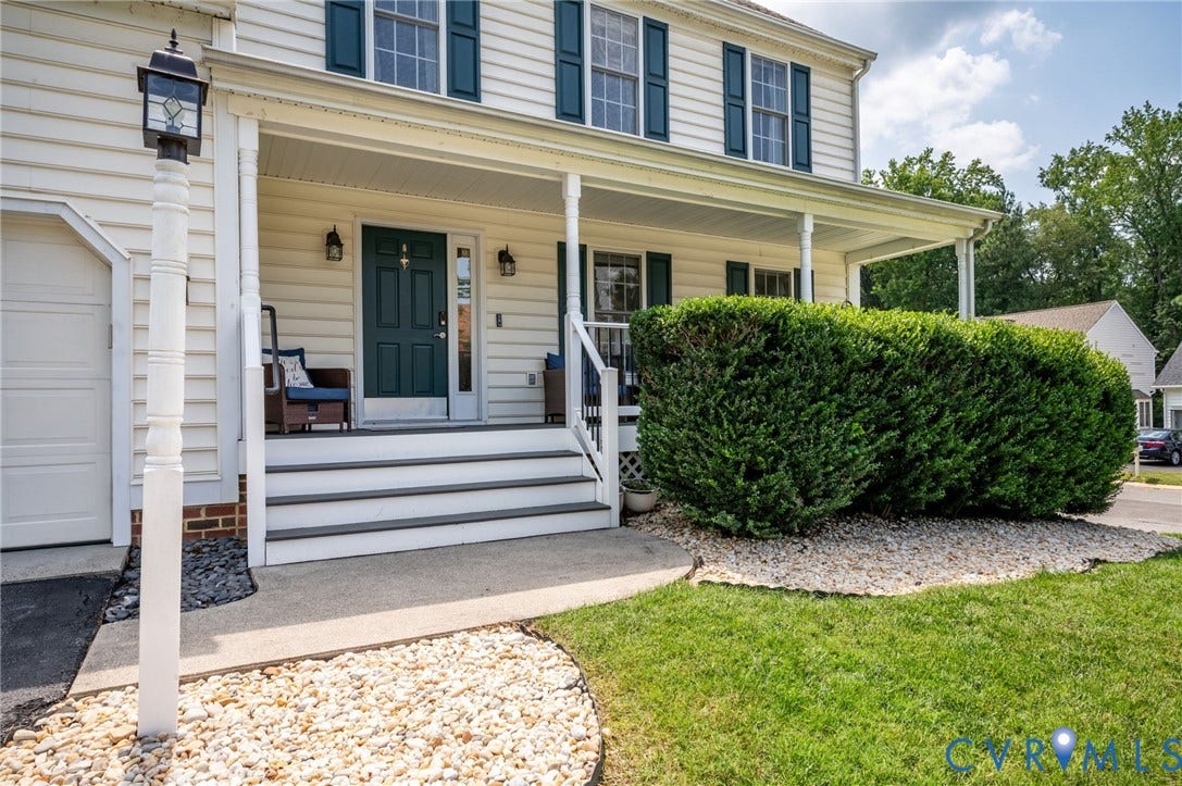 10620 Correnty Drive, Henrico, VA 23059 Front facade featuring a covered porch with white columns, a dark green entry door with sidelights, and exterior wall lanterns