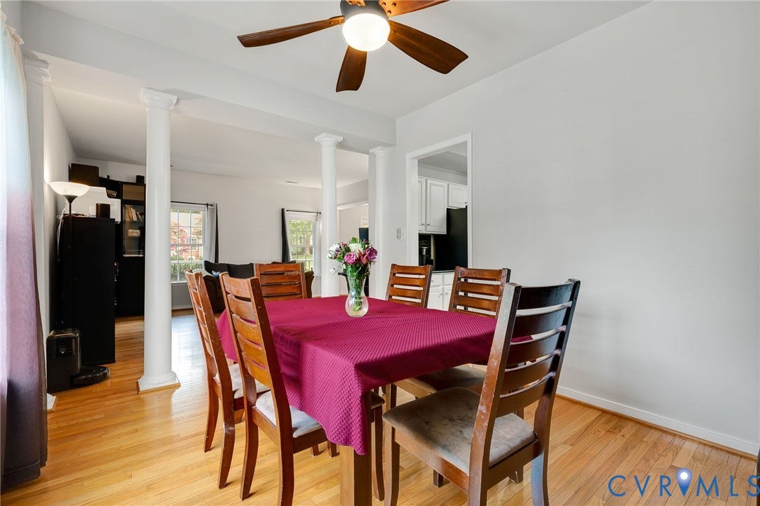 10620 Correnty Drive, Henrico, VA 23059 Formal dining area featuring wood-finish flooring, a ceiling fan with integrated lighting, and architectural columns