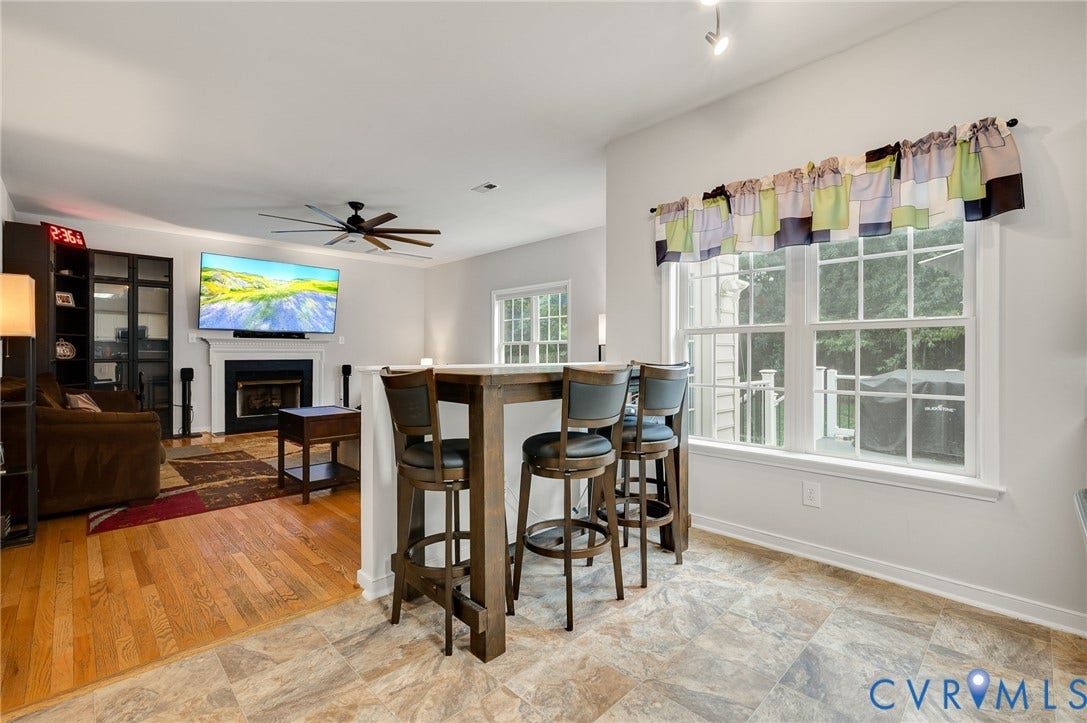 10620 Correnty Drive, Henrico, VA 23059 Kitchen bar seating opening to a living area with a fireplace