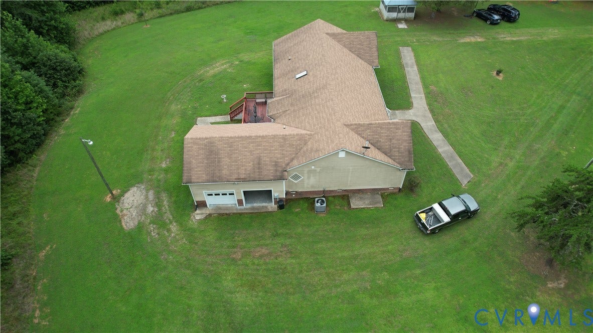 Amelia, VA 23966 Expansive green lawn surrounds this property featuring a multi-gabled roofline, an attached two-car garage, and a concrete pathway leading to the rear