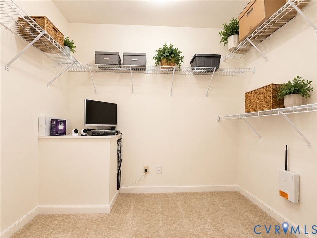 Amelia, VA 23966 Carpeted room featuring multiple wire shelving units, a built-in corner counter, and white baseboards