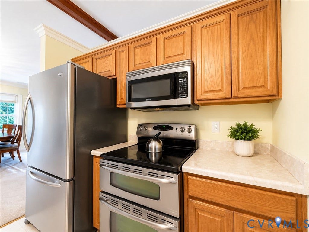 Amelia, VA 23966 Kitchen area featuring stainless steel appliances, wood-finish cabinetry, and light-toned countertops
