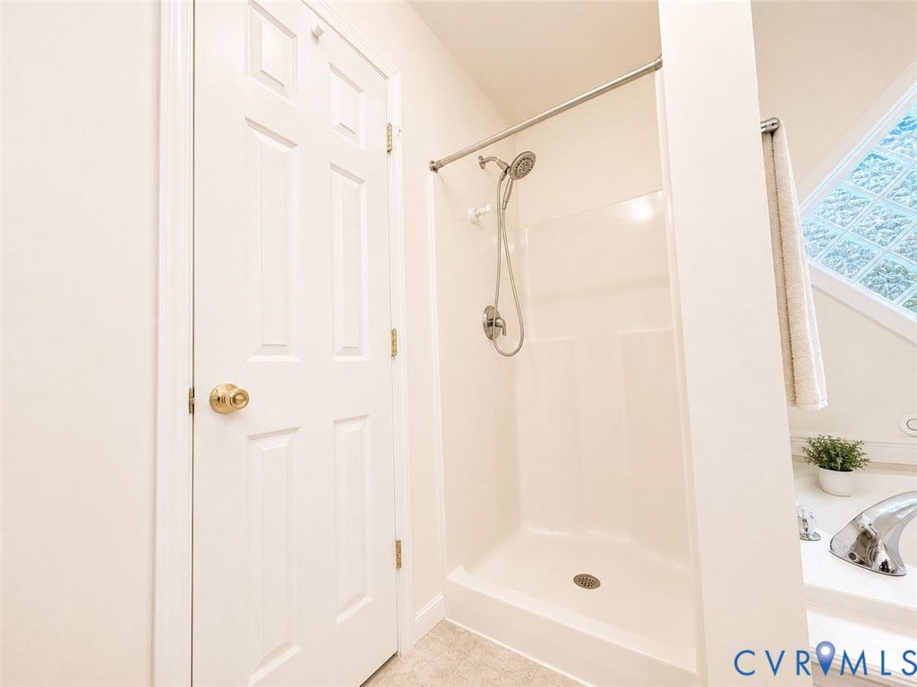 Amelia, VA 23966 Walk-in shower with a chrome fixture, surrounded by light-toned walls