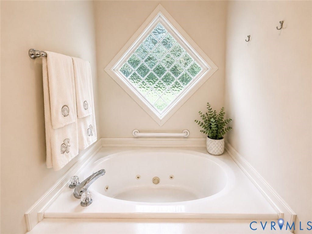 Amelia, VA 23966 Corner soaking tub with integrated jets and deck-mounted chrome fixtures