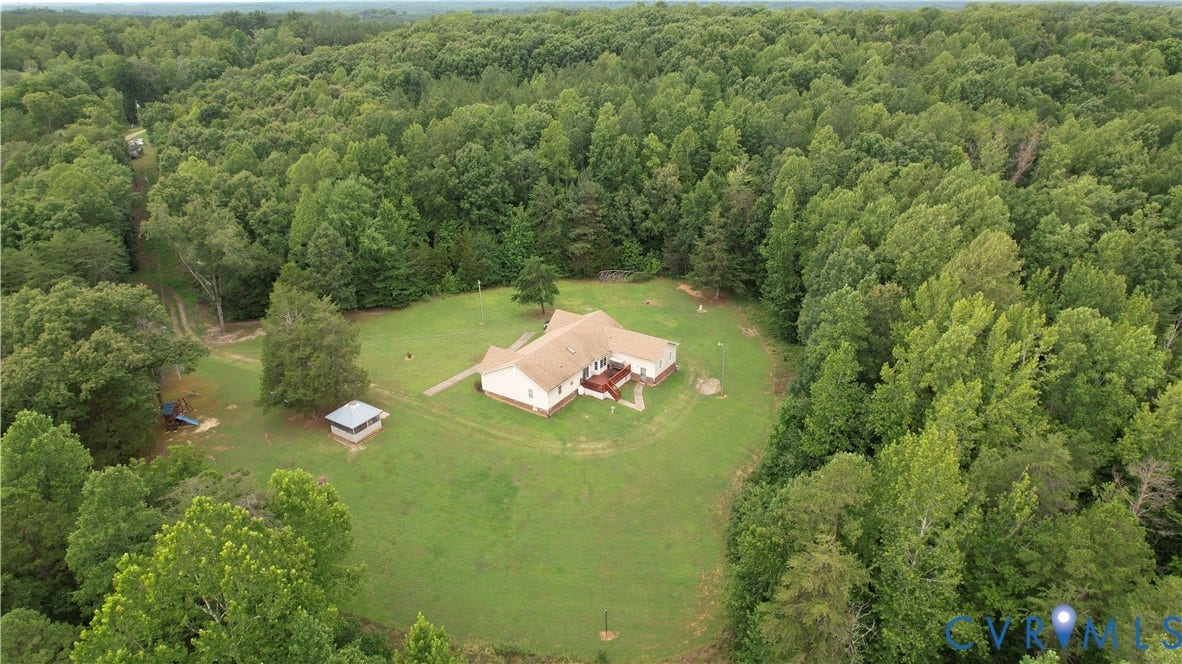 Amelia, VA 23966 Expansive treed acreage featuring a single-story residence with a light-colored exterior and a brown roof