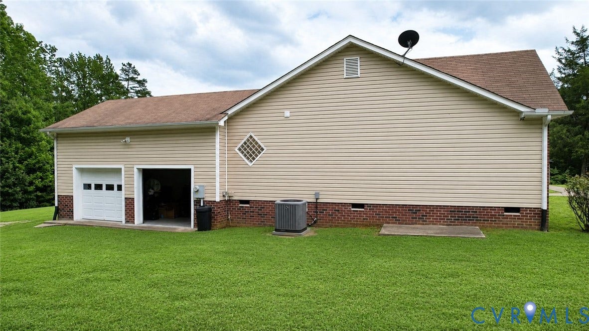 Amelia, VA 23966 Exterior featuring tan siding, a brown shingle roof, and a brick foundation
