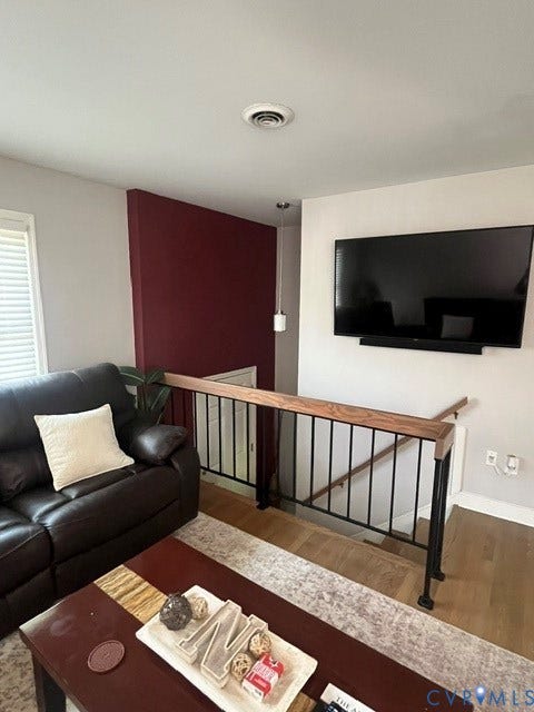 11925 Wedge Drive, Chester, VA 23831 Custom staircase with wood-finish railing and black metal spindles