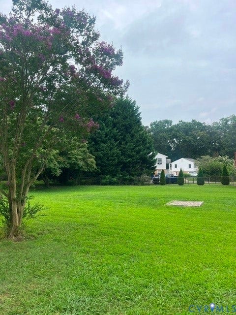11925 Wedge Drive, Chester, VA 23831 Expansive green lawn with mature trees and a flowering shrub
