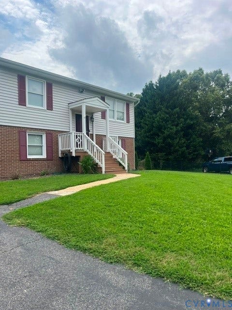 11925 Wedge Drive, Chester, VA 23831 Split-level home featuring brick and siding facade, a covered front entry with white railings, and a front yard with a paved driveway and concrete walkway