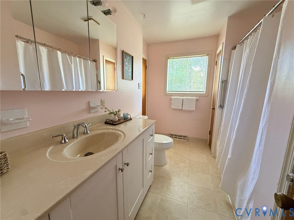 6401 Lythgoe Avenue, North Chesterfield, VA 23234 Vanity with integrated sink, chrome faucet, and white cabinetry