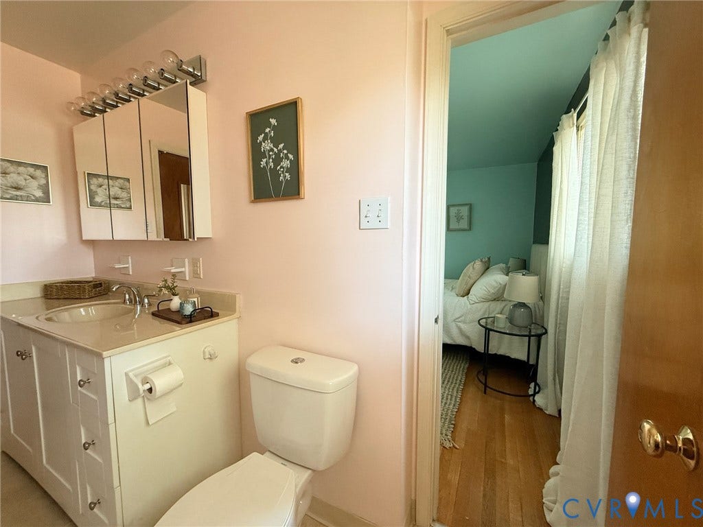 6401 Lythgoe Avenue, North Chesterfield, VA 23234 White vanity with an integrated sink and light-toned countertop