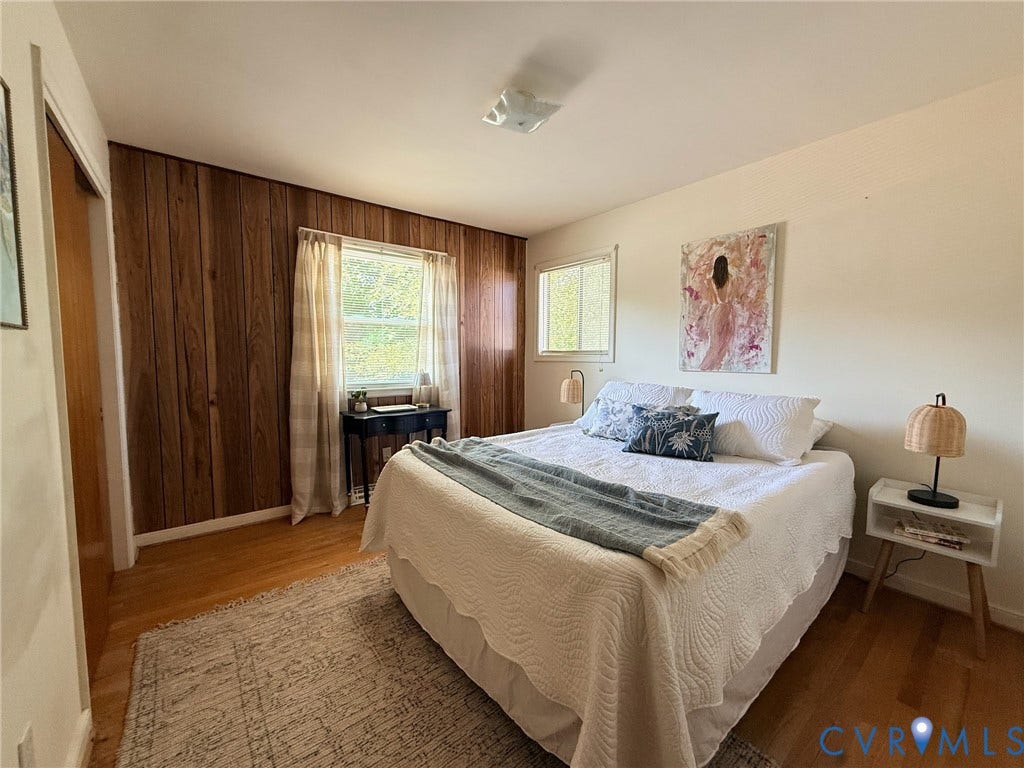 6401 Lythgoe Avenue, North Chesterfield, VA 23234 Wood-finish wall paneling, hard surface flooring, and multiple windows with natural light