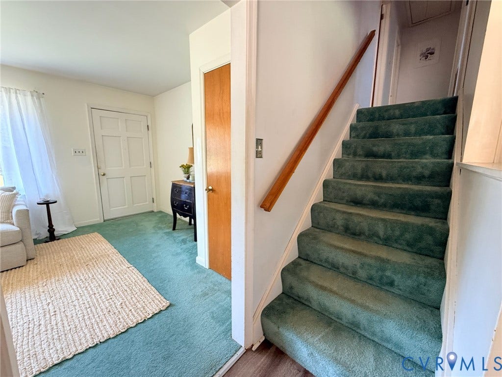 6401 Lythgoe Avenue, North Chesterfield, VA 23234 Carpeted staircase with a wood handrail