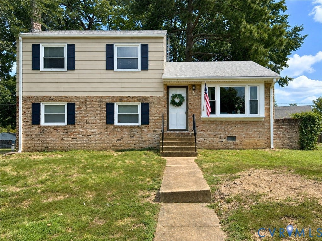 6401 Lythgoe Avenue, North Chesterfield, VA 23234 Two-story residence featuring a brick and siding exterior, multiple windows with dark shutters, a front entry with a white door, and a concrete pathway leading to the entrance