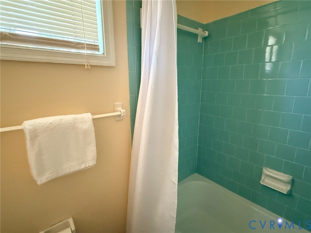6401 Lythgoe Avenue, North Chesterfield, VA 23234 Shower with green subway tile surround and white bathtub