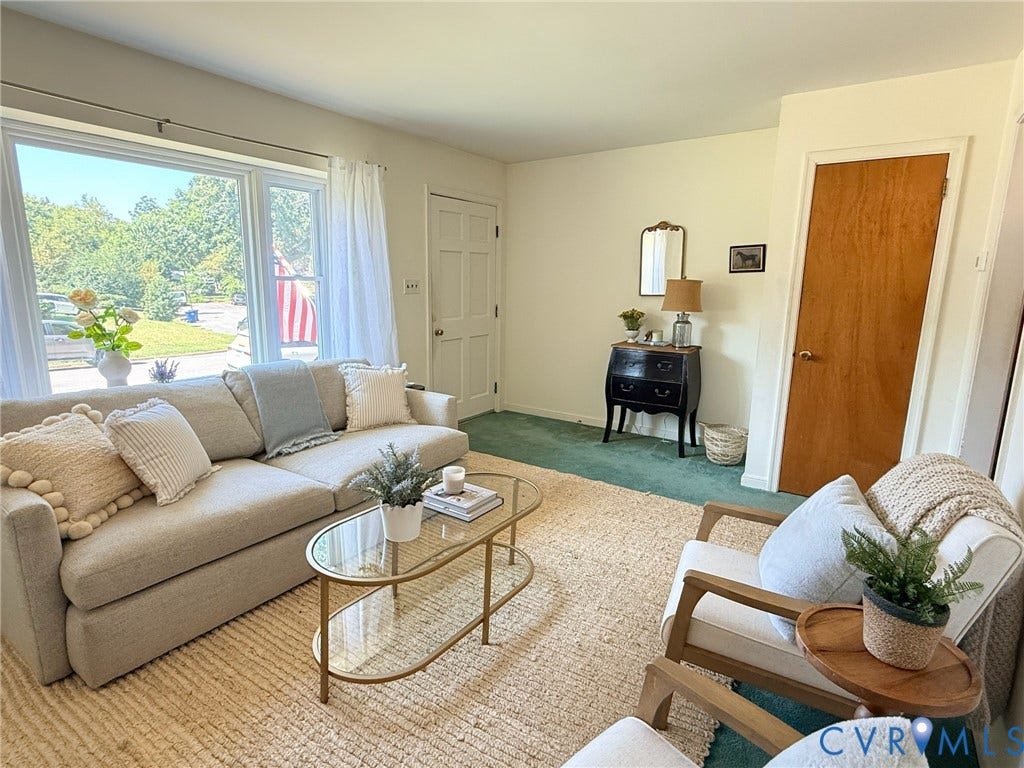 6401 Lythgoe Avenue, North Chesterfield, VA 23234 Large picture window, light-toned walls, wood-paneled door, and green carpet flooring