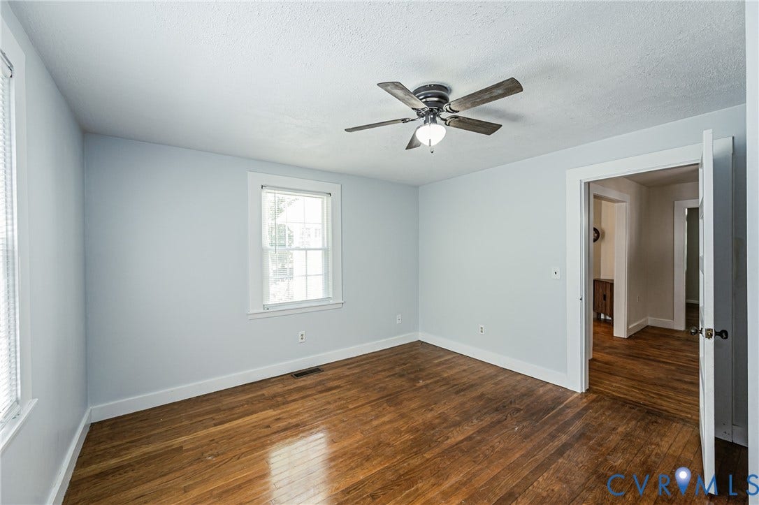 Interior room featuring wood-finish flooring and light-toned walls