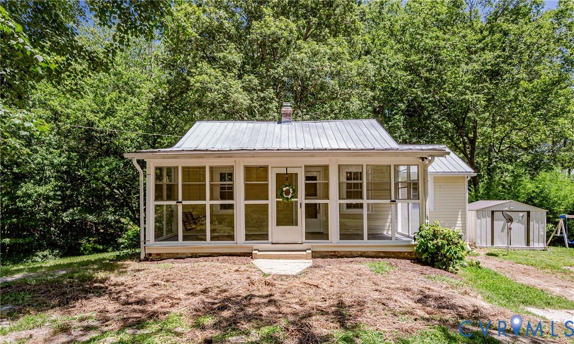 Exterior featuring a screened porch, metal roof, and light-colored siding