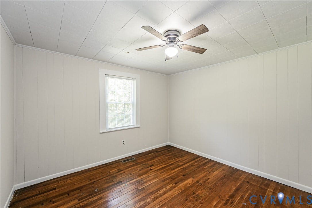 Hardwood flooring complements white panel walls