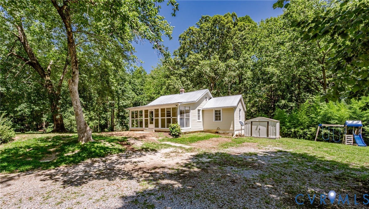 Single-story residence featuring a screened porch and a white exterior facade