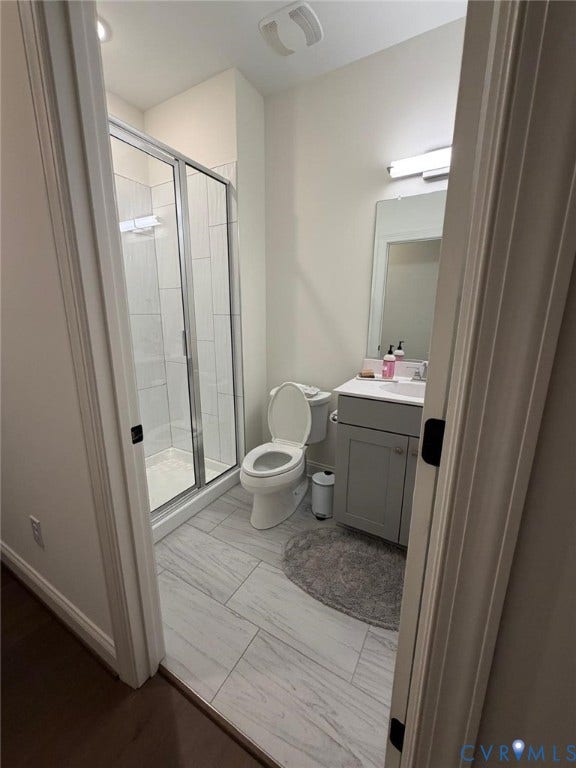 4516 Bacova Club Court, Glen Allen, VA 23059 Enclosed shower with glass doors, large format tile flooring, single vanity with integrated sink, and overhead lighting