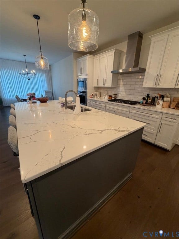 4516 Bacova Club Court, Glen Allen, VA 23059 Kitchen with a large island featuring a light-toned countertop, wood-finish flooring, white cabinetry, and stainless steel appliances including a range hood and wall oven