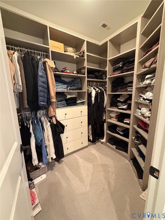 4516 Bacova Club Court, Glen Allen, VA 23059 Custom built-in closet system featuring multiple hanging rods, integrated shelving, and a built-in dresser with four drawers