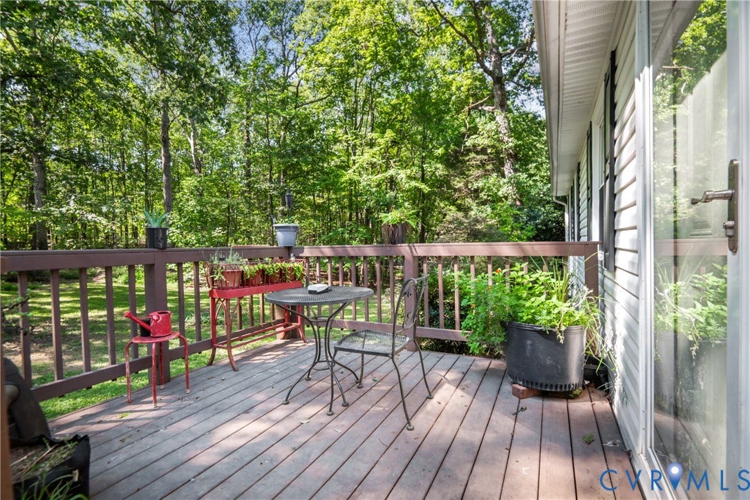 3940 Three Bridge Road, Powhatan, VA 23139 Expansive wood-finish deck with railing, sliding glass door, and exterior siding