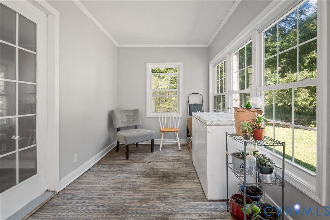 3940 Three Bridge Road, Powhatan, VA 23139 Light-filled room featuring multiple large windows, a French door with glass panels, and wood-finish flooring