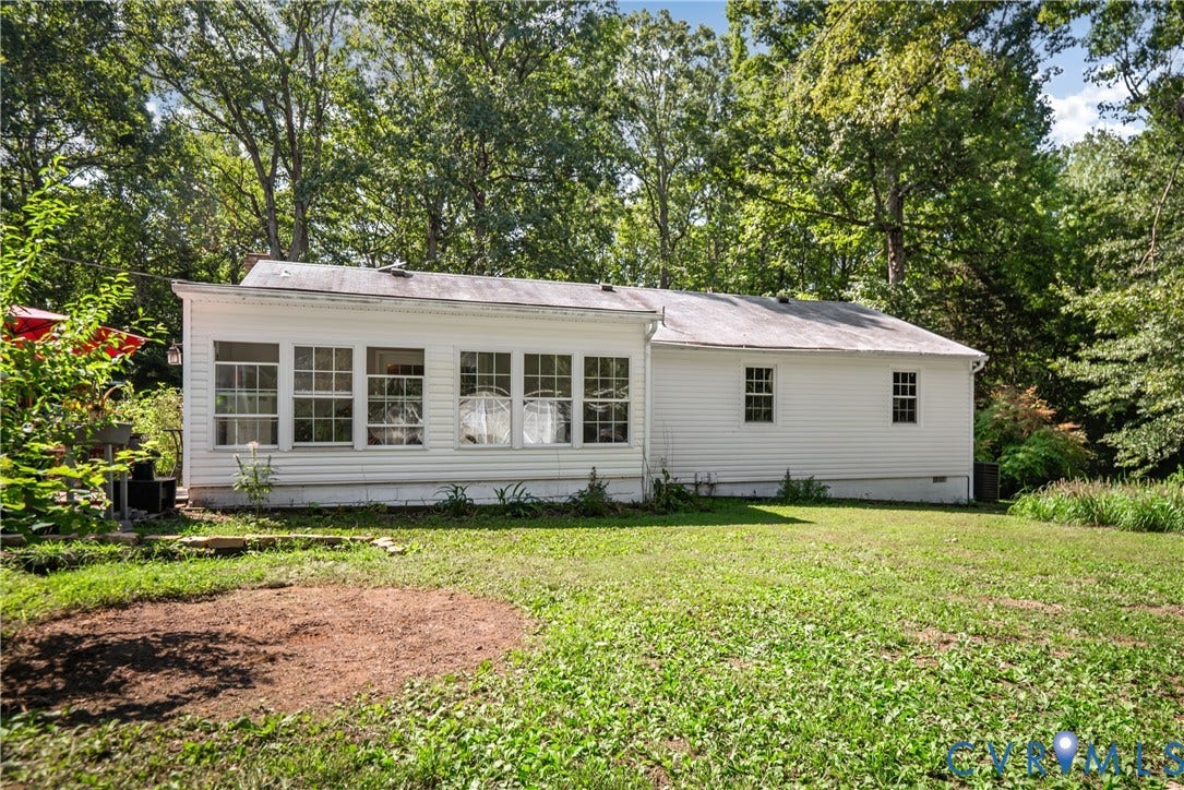 3940 Three Bridge Road, Powhatan, VA 23139 Expansive green space surrounding the structure, featuring a white siding exterior and multiple windows