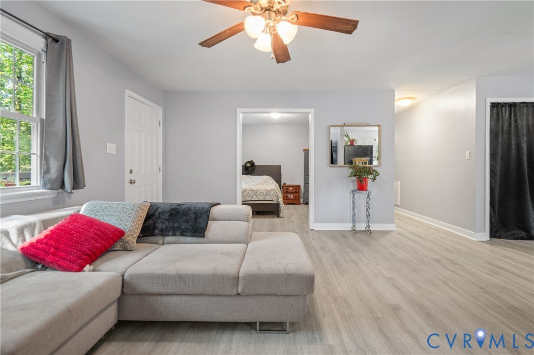 3940 Three Bridge Road, Powhatan, VA 23139 Light grey wall paint, wood-finish flooring, white window trim, ceiling fan light fixture, and white interior door