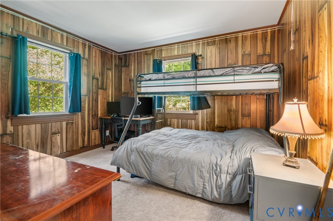 3940 Three Bridge Road, Powhatan, VA 23139 Wood-paneled walls and a light-colored carpeted floor create a distinctive interior