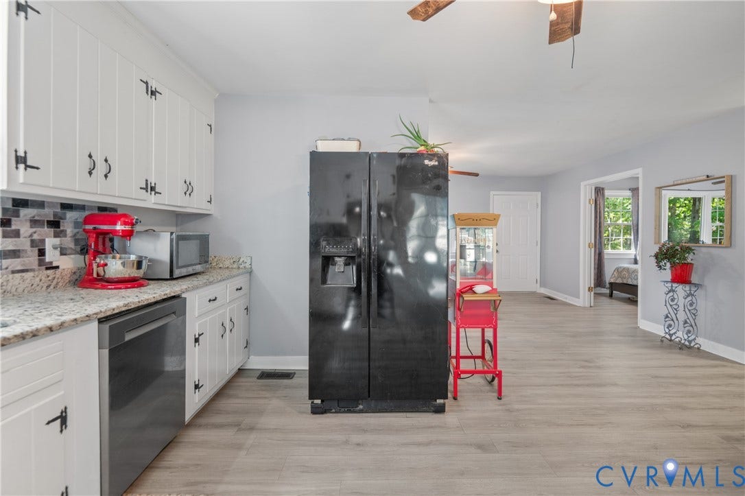 3940 Three Bridge Road, Powhatan, VA 23139 White cabinetry with black hardware, granite countertops, tile backsplash, and wood-finish flooring