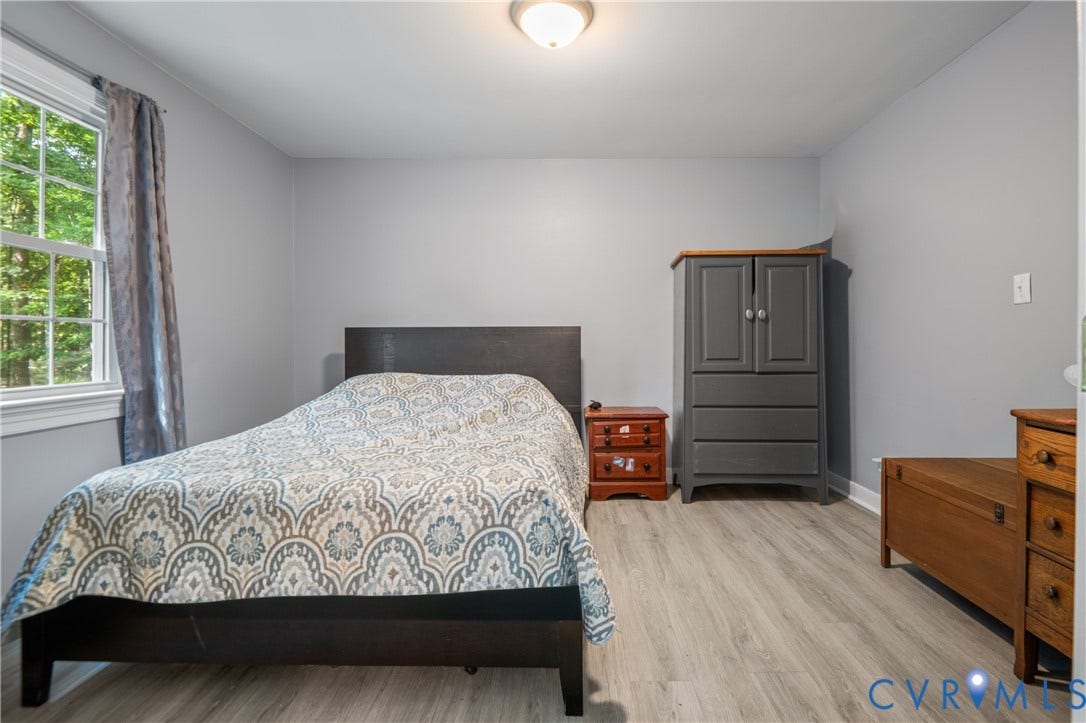 3940 Three Bridge Road, Powhatan, VA 23139 Light grey walls, wood-finish flooring, and a single window with white trim