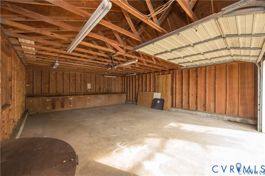 3940 Three Bridge Road, Powhatan, VA 23139 Concrete flooring, exposed wood beam ceiling, wood plank wall finishes, built-in lower cabinetry, and overhead lighting
