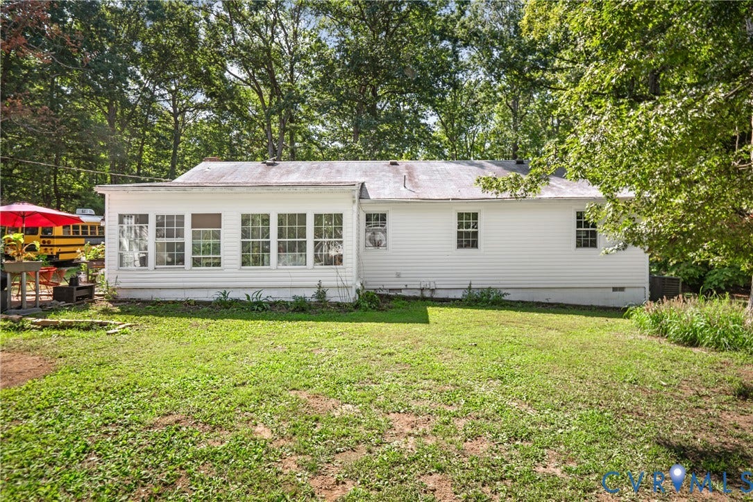 3940 Three Bridge Road, Powhatan, VA 23139 White siding exterior with multiple windows, a sunroom with large windows, and a metal roof