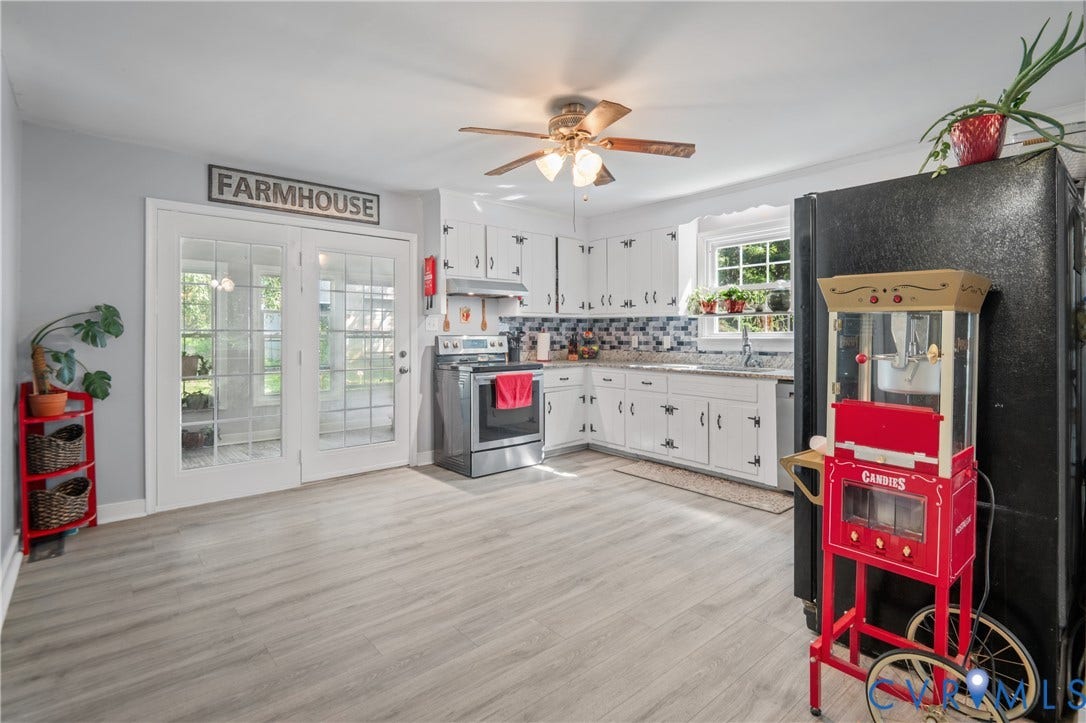 3940 Three Bridge Road, Powhatan, VA 23139 White cabinetry with black hardware, light-toned wood-finish flooring, and light gray wall paint