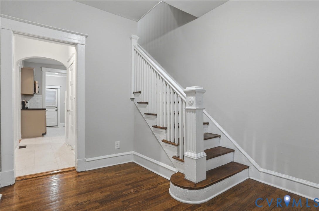 3110 3rd Avenue, North Highland Park, Richmond, VA 23222 Hardwood flooring and a staircase with white balusters and a decorative newel post