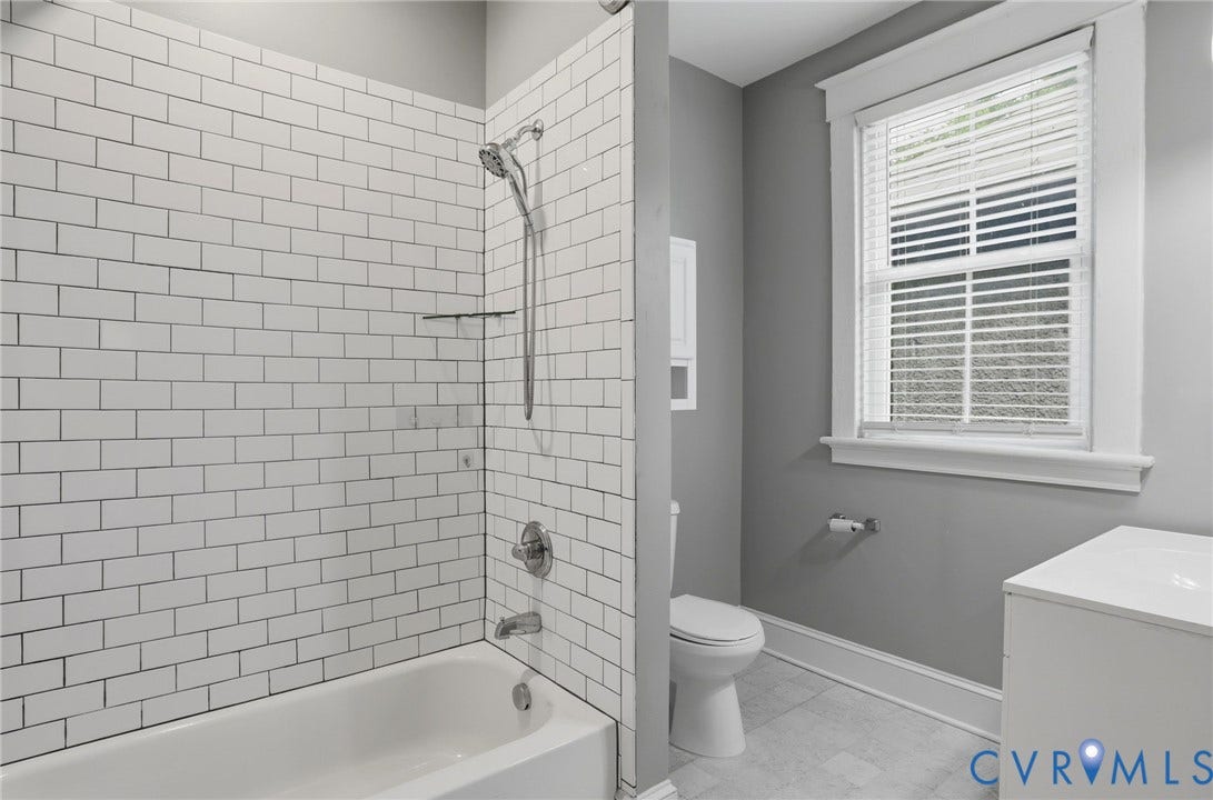 3110 3rd Avenue, North Highland Park, Richmond, VA 23222 Bathroom featuring a tub/shower combination with white subway tile surround, chrome fixtures, and a white vanity with a rectangular sink