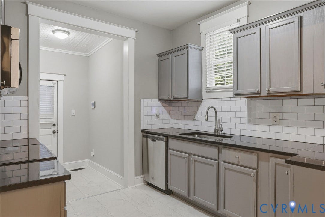 3110 3rd Avenue, North Highland Park, Richmond, VA 23222 Kitchen featuring light gray cabinetry, dark countertops, a subway tile backsplash, stainless steel appliances, and tile flooring