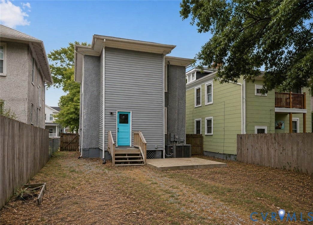 3110 3rd Avenue, North Highland Park, Richmond, VA 23222 Rear exterior featuring a vibrant blue door, wooden steps, and a concrete patio