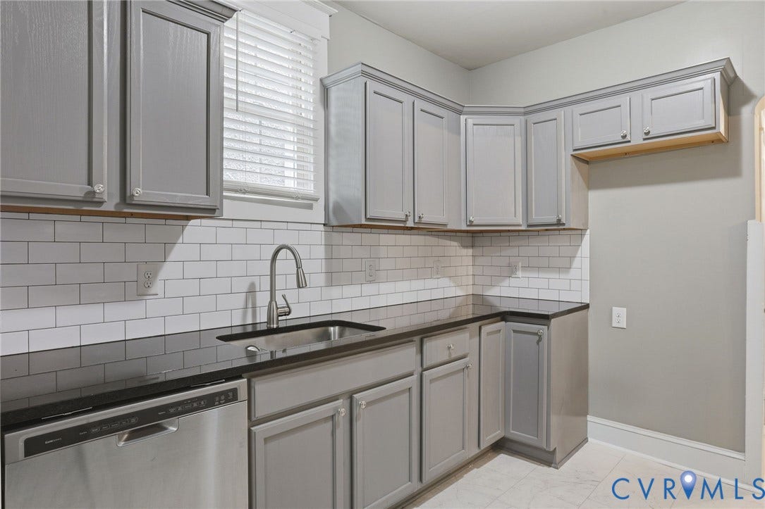3110 3rd Avenue, North Highland Park, Richmond, VA 23222 Kitchen featuring gray cabinetry, dark countertops, white subway tile backsplash, stainless steel sink with a modern faucet, and a stainless steel dishwasher