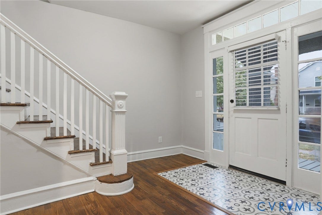 3110 3rd Avenue, North Highland Park, Richmond, VA 23222 Foyer featuring a grand staircase with white risers and wood-finish treads, wood-finish flooring, patterned tile entry, and a front door with sidelights and transom windows