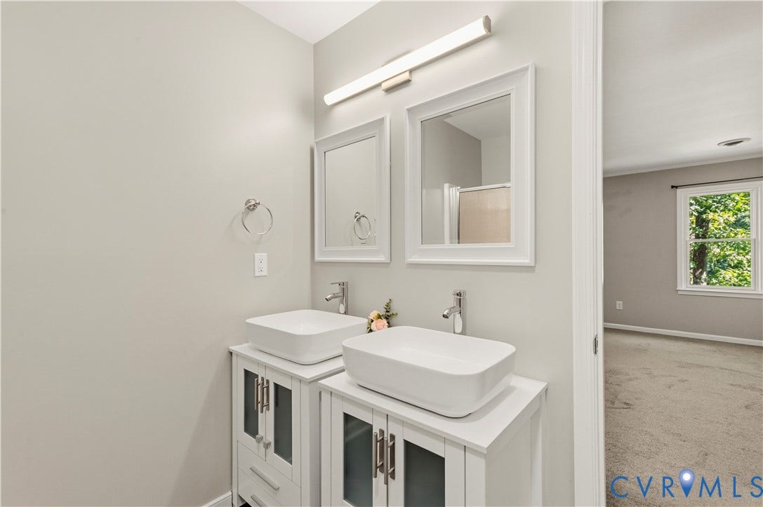9007 Chatham Grove Lane, Richmond, VA 23236 Primary ensuite bathroom - Dual vessel sinks set on separate vanities with framed mirrors and linear overhead lighting