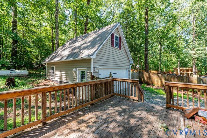 9007 Chatham Grove Lane, Richmond, VA 23236 Attached garage with two bays, durable metal roof, and a dormer window