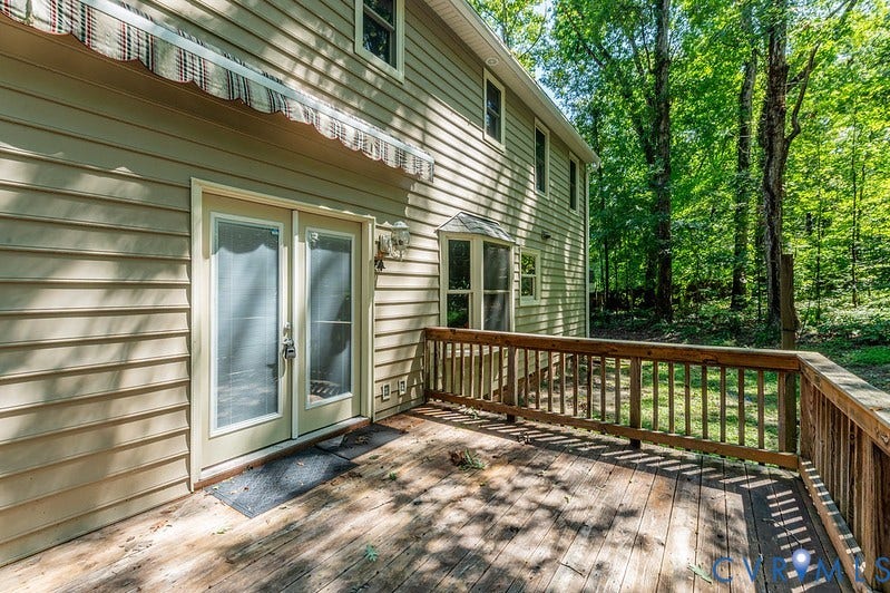 9007 Chatham Grove Lane, Richmond, VA 23236 Outdoor deck with wooden railing and mature trees